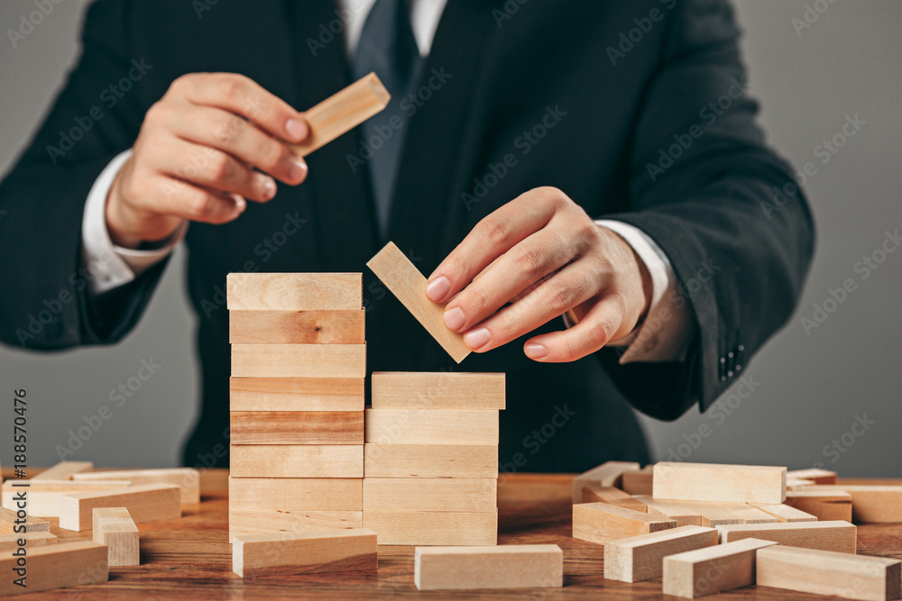 Man and wooden cubes on table. Management concept Man and wooden cubes on table. Management concept