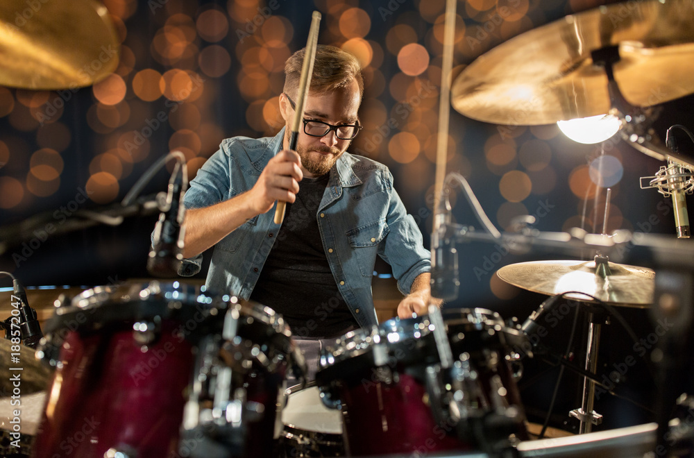 Fototapeta premium musician playing drum kit at concert over lights
