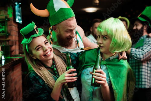 Man in a Viking hat flirting with two girls.
