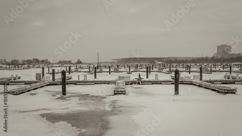 Boat docks sitting empty with sheets of ice and snow