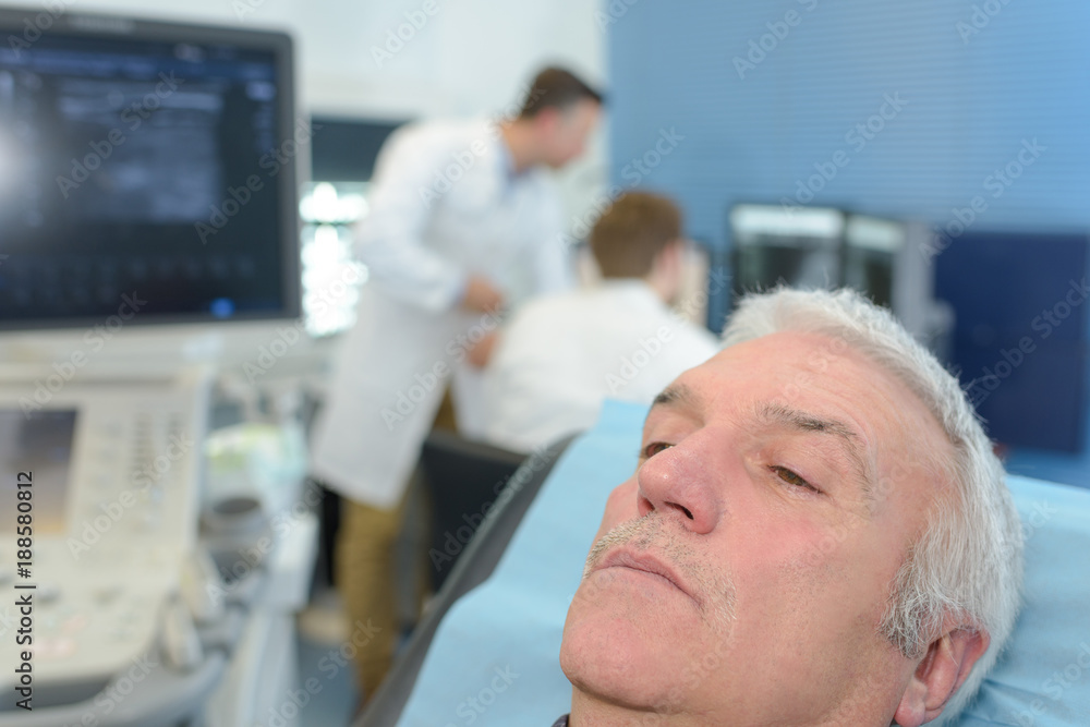 senior patient sitting on bed in hospital senior patient sitting on bed in hospital