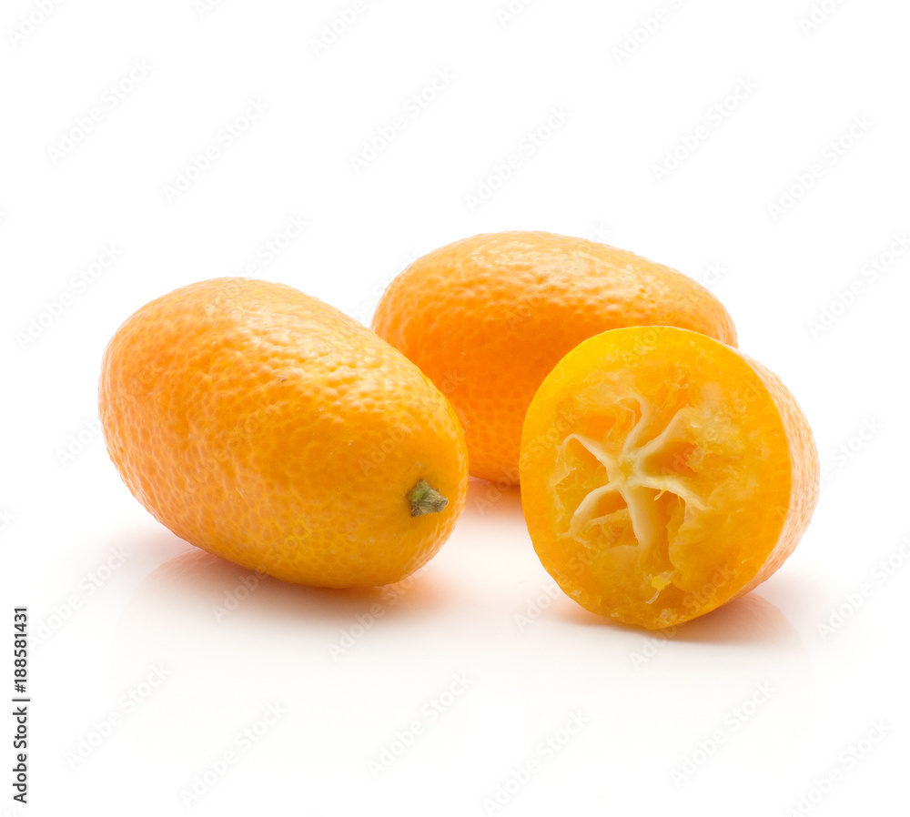 Two kumquat one sliced half isolated on white background. Two kumquat one sliced half isolated on white background.