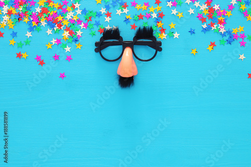 Carnival celebration concept with funny mustache glasses. Top view.