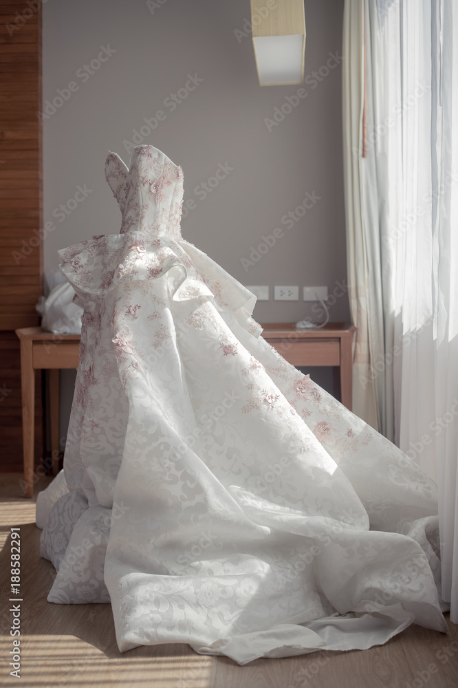 Fototapeta premium Beautiful wedding dress with window light