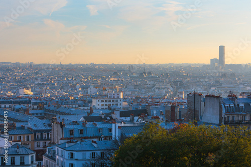 Evening panoramic cityscape downtown of Paris in backlit sunbeam. View from the Basilica of Sacre-Coeur.