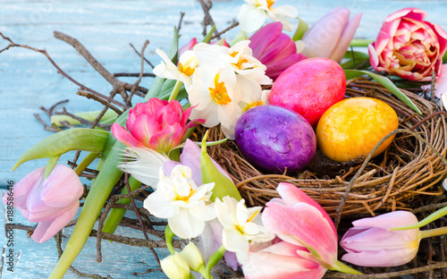Happy Easter: nest with Easter eggs, feathers, tulips and daffodils:)