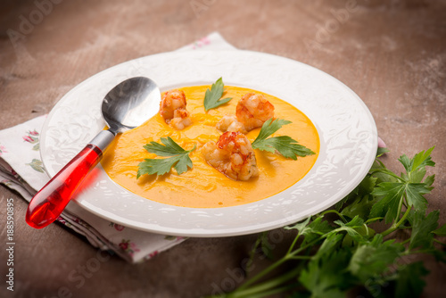 soup with carrot pumpkin and shrimp, selective focus