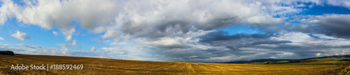 a field with a beautiful sky, a hunting place, and birds