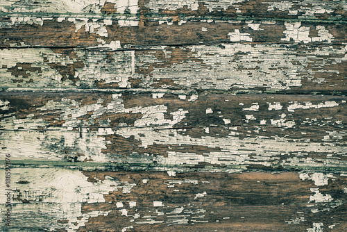 Vintage ripped wooden background with traces of old paint