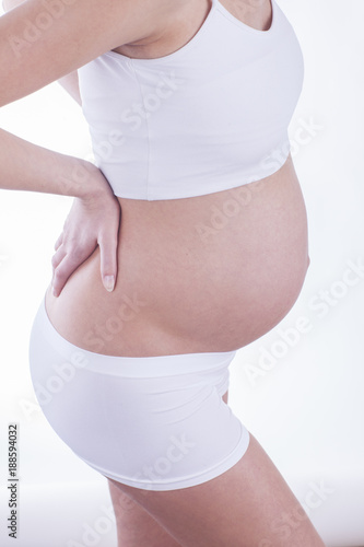 Close up of the pregnant woman who is having a back pain.