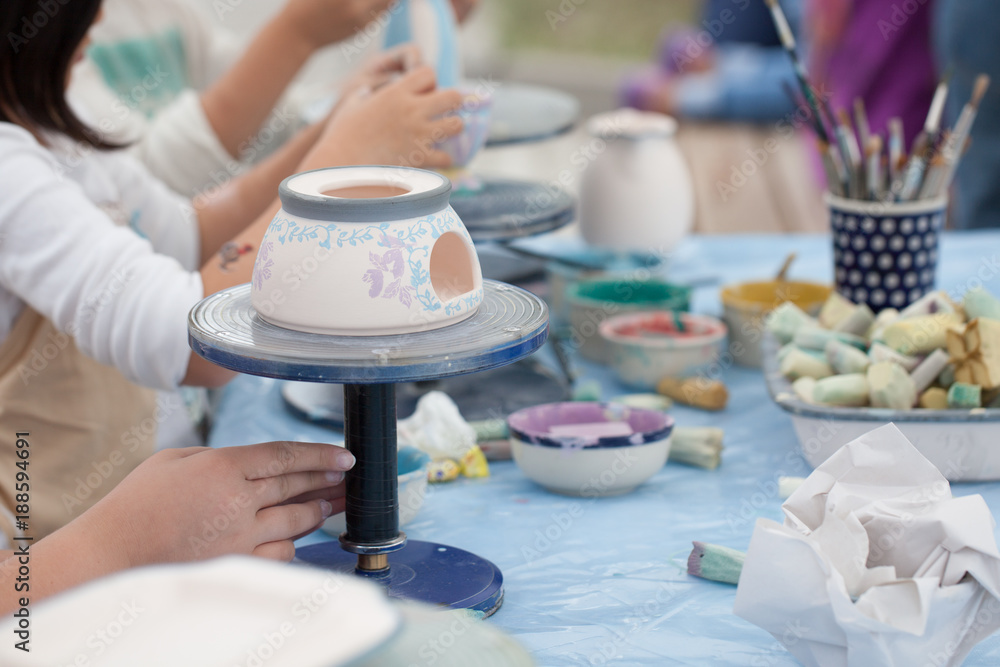 painting ceramics - children painting ceramic dishes