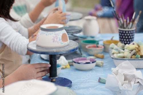 painting ceramics - children painting ceramic dishes
