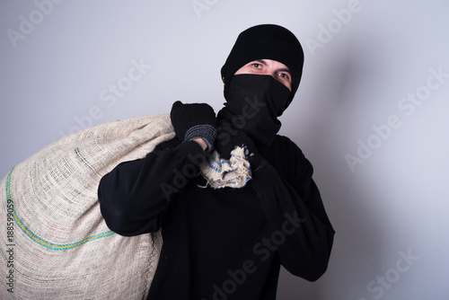 robber with pray on his back  photo