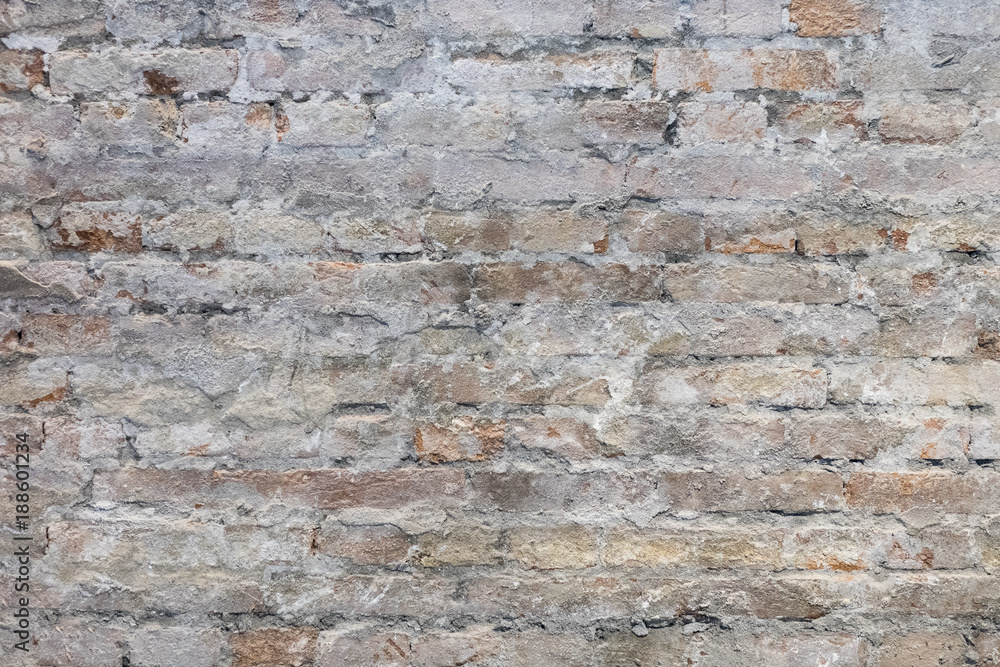 Fototapeta premium Modern brick wall background, Renovated brick wall in interior, Cracked plaster texture, Beautiful interior brick wall, Industrial hipster wall, Abstraction building background