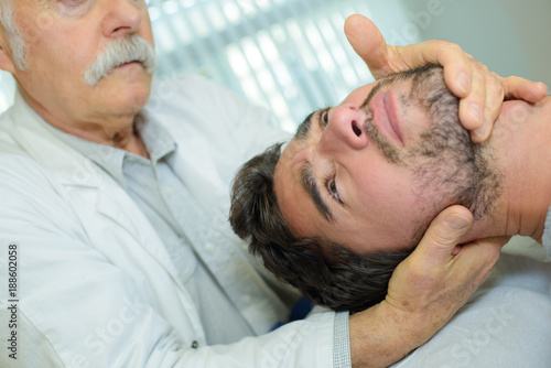 physical therapist giving neck massage