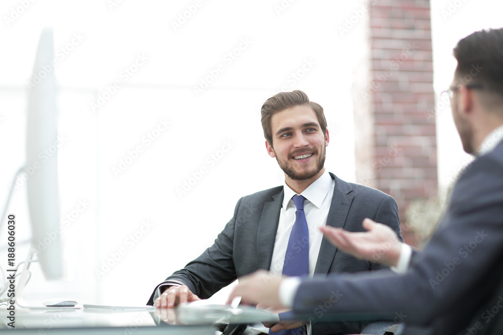 Image of two young businessmen interacting at meeting in office Image of two young businessmen interacting at meeting in office
