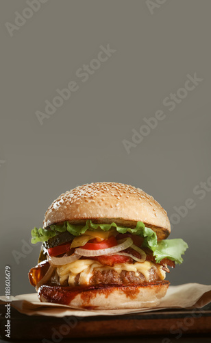 mouth-watering delicious homemade burger used to chop beef on the wooden table.