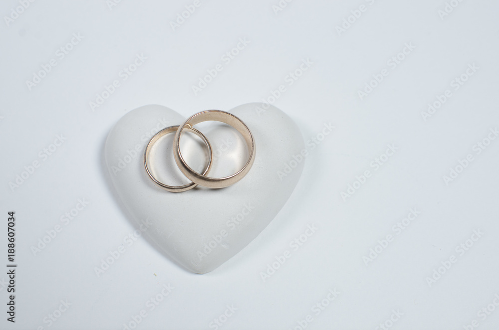 Wedding rings on a white background. Postcard to the day of all lovers. Wedding rings on a white background. Postcard to the day of all lovers.