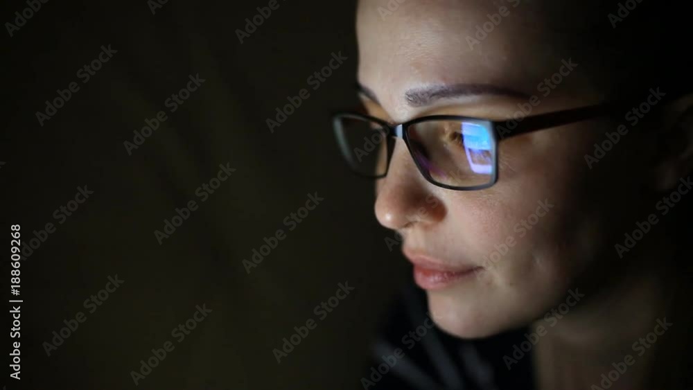 Woman using Tablet Computer at night.. Young millennial consumer shopping online from home, lying on bed. Technology in everyday life. Woman using Tablet Computer at night.. Young millennial consumer shopping online from home, lying on bed. Technology in everyday life.
