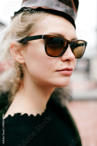 Closeup portrait of odd bizarre kinky beautiful cute young famous celebrity fashion caucasian blonde model woman in rich modern trendy sunglasses. Lovely girl posing for camera in stylish clothing.