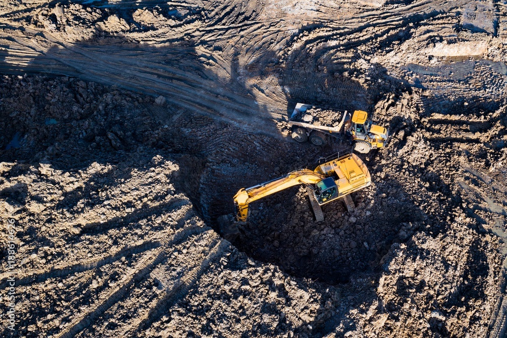 Aerial drone view of excavator loading the tipper truck Aerial drone view of excavator loading the tipper truck