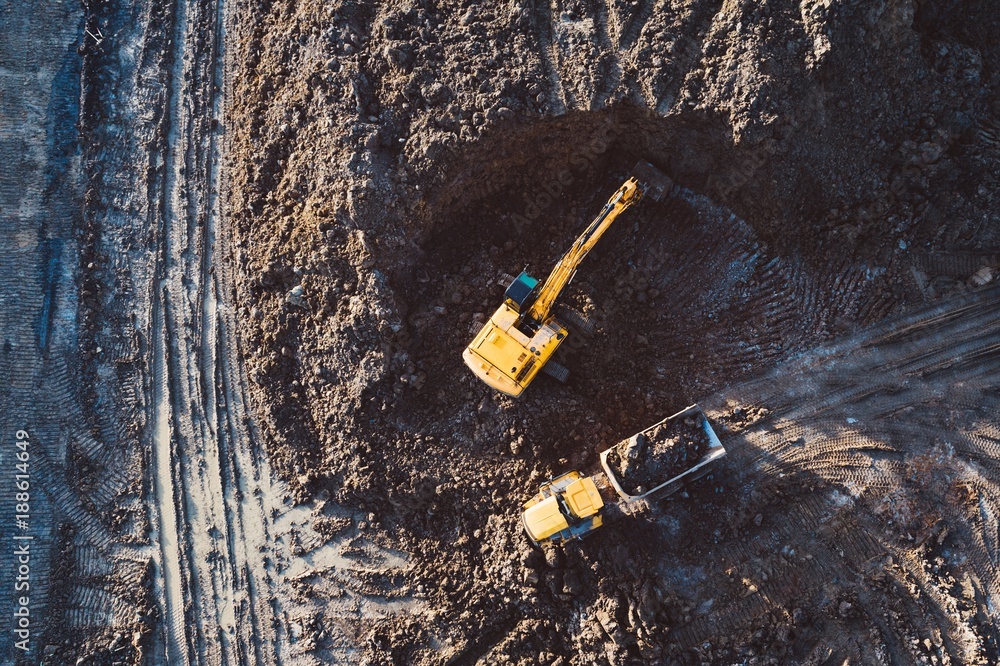 Aerial drone view of excavator loading the tipper truck