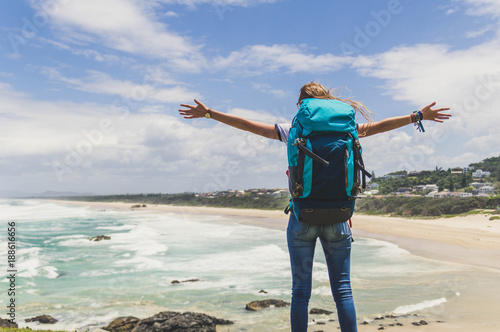 Freedom concept. Traveller woman in the top of the mountain enjoying landscape  photo