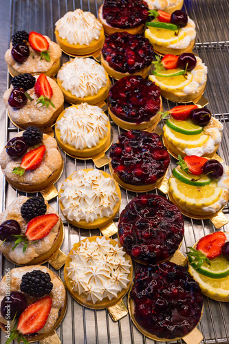 Dessert tartlets with fruit and berries top view © Yakov