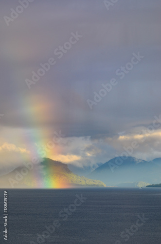 rainbow over lake and mountains
