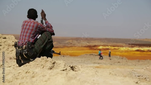 ETHIOPIA,DALLOL-CIRCA  DECEMBER 2017--unidentified soldier looking for the tourist in volcano depression
