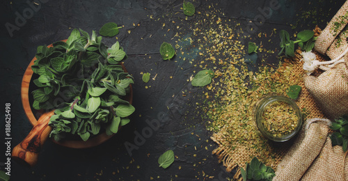 Dried ground oregano or marjoram, dark background, top view