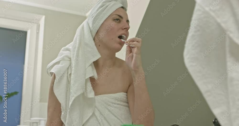 Healthy young woman brushing teeth in bathroom. Healthy young woman brushing teeth in bathroom.