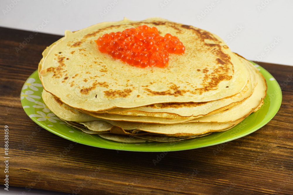 Traditional Russian pancakes with red caviar