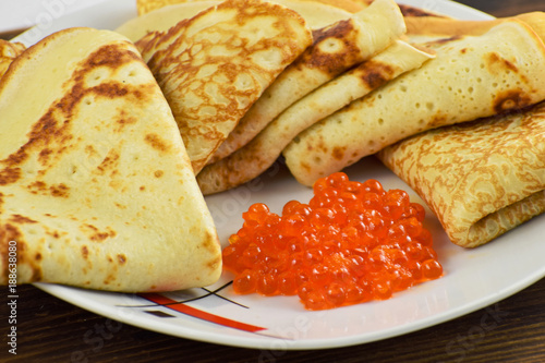 Traditional Russian pancakes with red caviar.