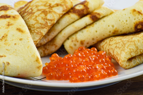 Traditional Russian pancakes with red caviar. photo