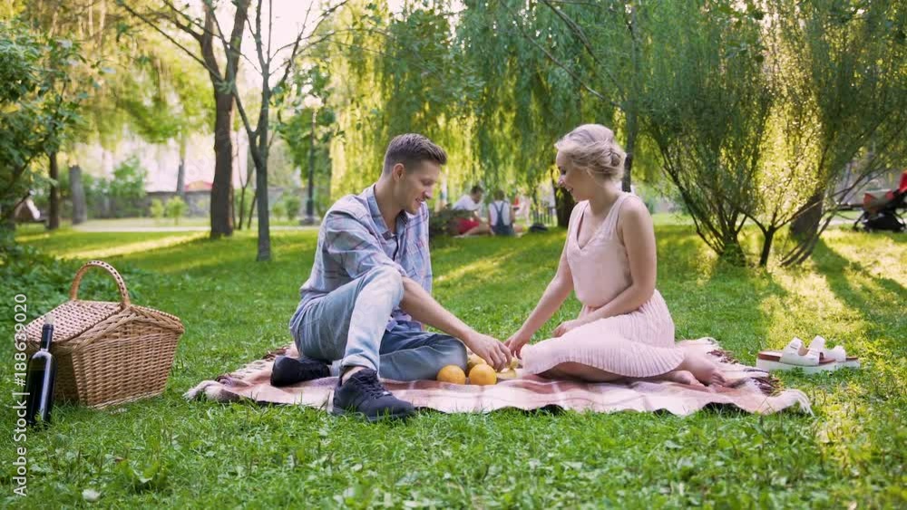 Young loving couple laughing and having fun, spending date time in public park Young loving couple laughing and having fun, spending date time in public park