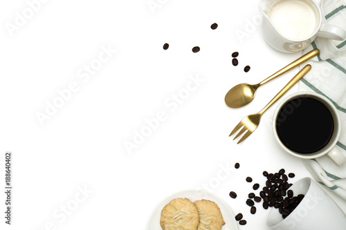 Mockup breakfast on white background with a cup of coffee, coffee beans, milk and cookie. Top view with copy space, flat lay.