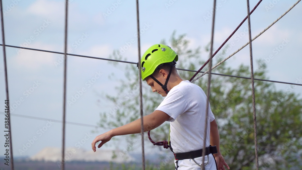 Teenager in helmet on the cable car Teenager in helmet on the cable car