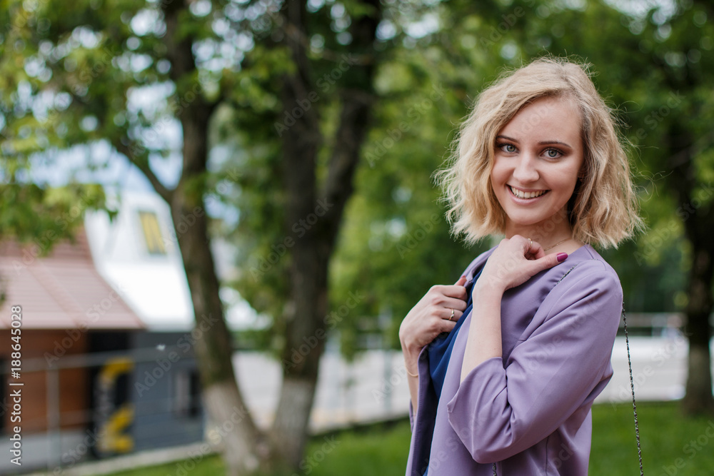 Portrait attractive girl with blond hair in a park Portrait attractive girl with blond hair in a park