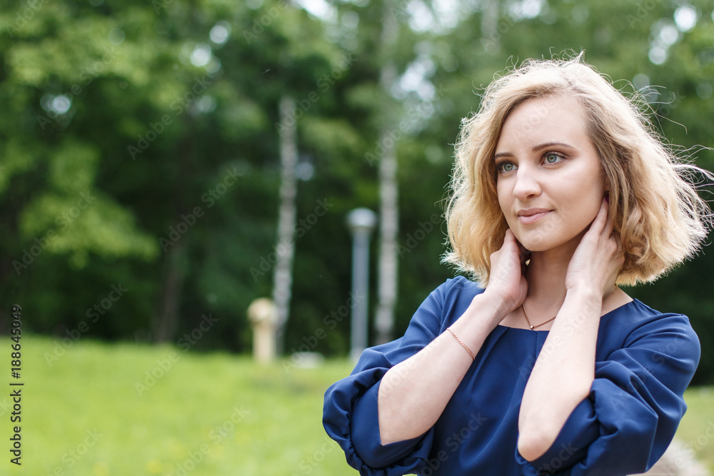 Portrait attractive girl with blond hair in a park Portrait attractive girl with blond hair in a park
