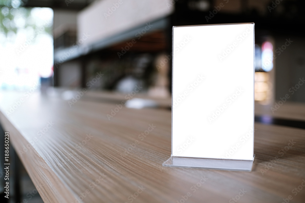Mock up Menu frame standing on wood table in Bar restaurant cafe. space for text Mock up Menu frame standing on wood table in Bar restaurant cafe. space for text