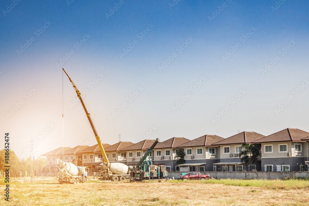 Fototapeta premium House building at construction site with crane truck