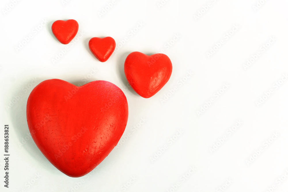 A red hearts of different sizes isolated on white background