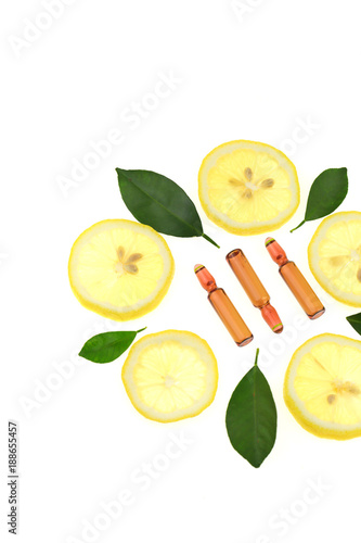 Vitamin C.ampoules with vitamin c and pieces of citrus fruit on a white background. Health and Beauty