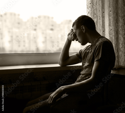 Disabled person by window