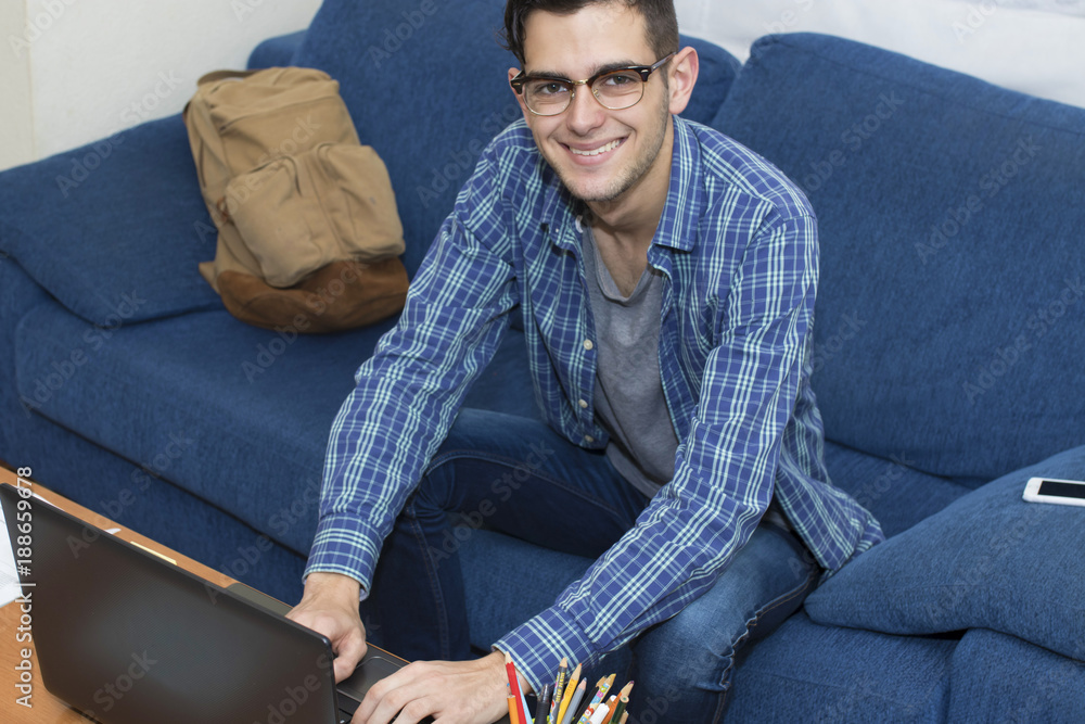 Fototapeta premium young adult working or studying with the computer at home