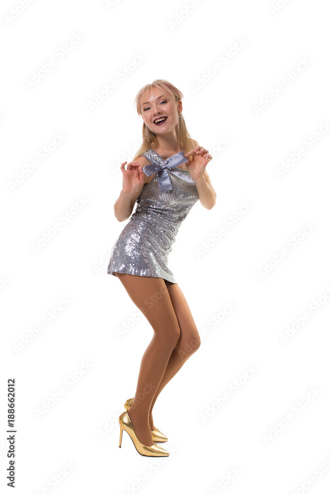 sexy girl dancing in the studio on a white background in a shiny dress - isolated sexy girl dancing in the studio on a white background in a shiny dress - isolated
