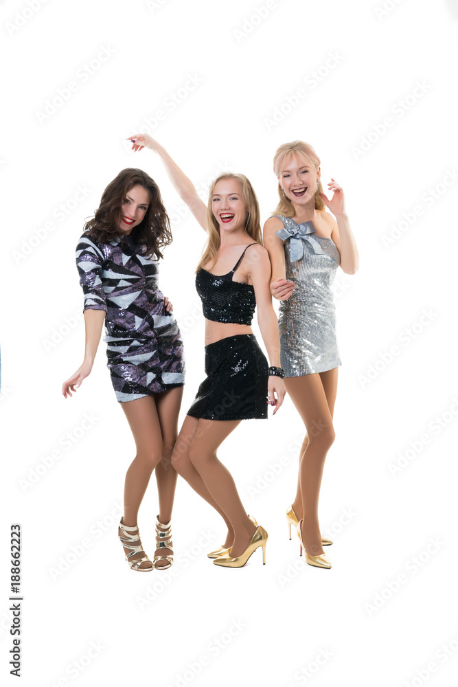 Obraz premium 3 beautiful girls at a party dancing on a white background - isolated