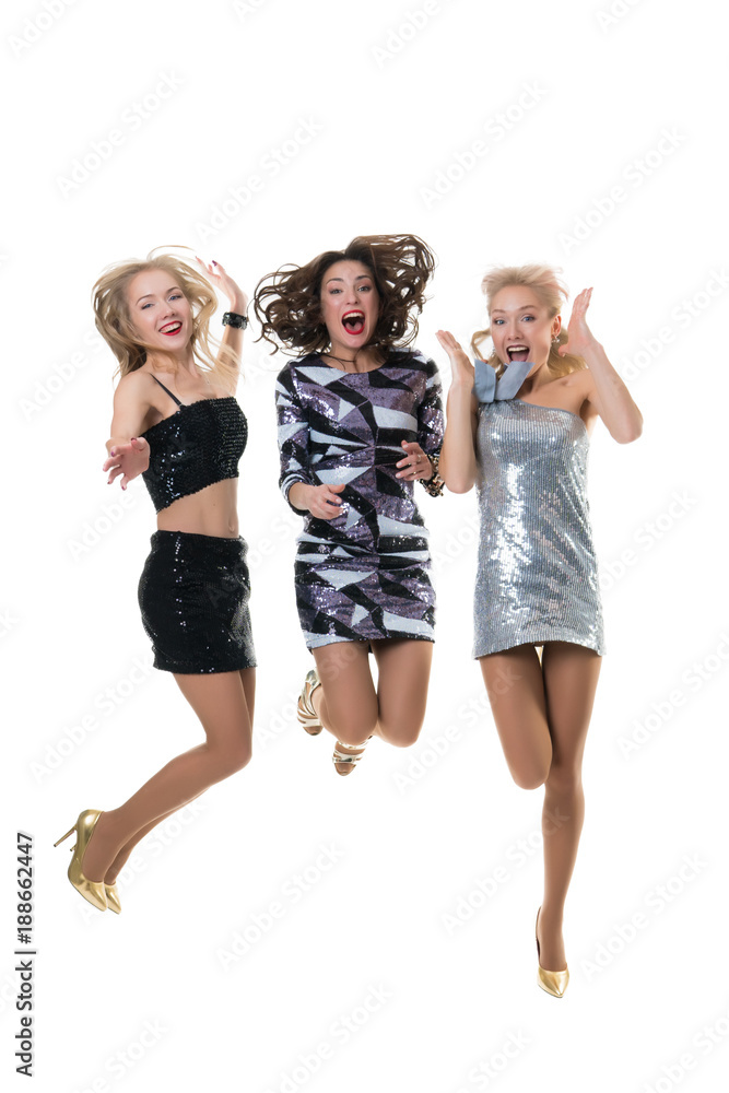 3 beautiful happy girls are jumping in the studio on a white background isolated. the joy of shopping. freezing jump - the flight of girls. 3 beautiful happy girls are jumping in the studio on a white background isolated. the joy of shopping. freezing jump - the flight of girls.