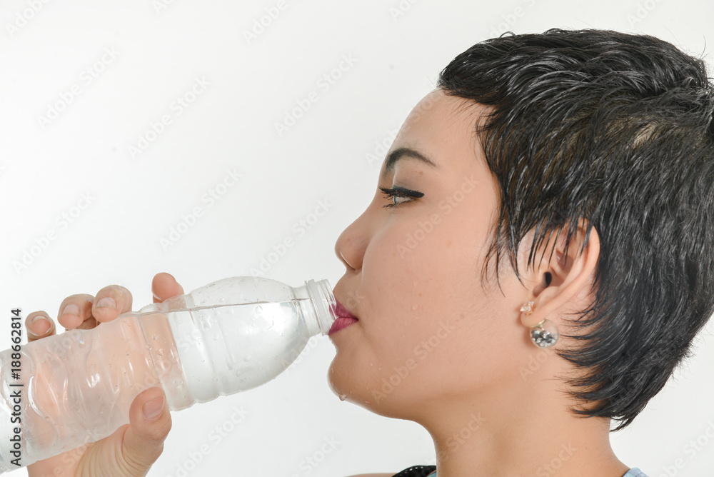Smart Asian woman drinking a bottle of water, healthy concept. Smart Asian woman drinking a bottle of water, healthy concept.